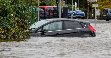 Storm Ashley arrives: The Rivern Servern has burst its banks causing flooding in Worcester today. Here a car is stuck in floodwater on Pitchcroft Carpark. Here a car is swamped up to its wingmirrors