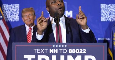 Republican presidential candidate former President Donald Trump, left, listens as Sen. Tim Scott, R-S.C., speaks at a campaign event in Concord, New Hampshire