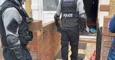NCA officers arresting individuals suspected of creating the Russian Coms phone spoofing platform