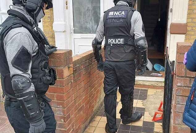 NCA officers arresting individuals suspected of creating the Russian Coms phone spoofing platform
