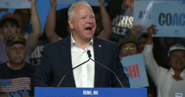Tim Walz speaking at a campaign rally.