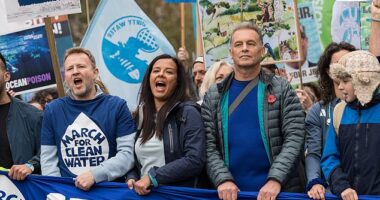 Liz Bonnin (centre) and naturalist Chris Packham (centre right) take part in March for Clean Water demanding the new government enforce the current law and deliver new legislation that will end all pollution