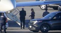 Secret Service agents are seen here as the ex First Lady makes her way on to a private plane in New York on Sunday