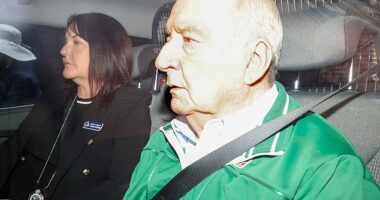 Veteran broadcaster and former Wallabies coach Alan Jones was charged with 24 offences involving eight alleged victims (pictured: Jones being driven to the police station)