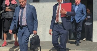 A shattered Mick Murphy (far right) leaves the Ballarat Magistrates' Court behind police and the prosecutor