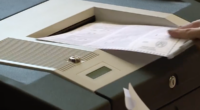 voting inserting ballot into scanner