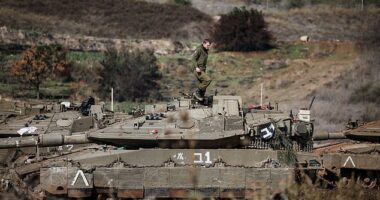 An Israeli soldier stands on a military vehicle waiting in position near a road close to the Israel-Lebanon border November 28, 2024