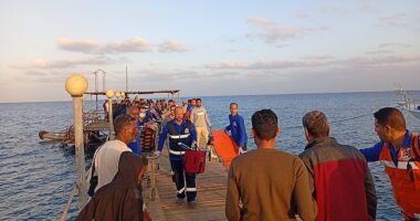 Rescuers and medics are seen on a pontoon after the boat capsized early yesterday morning