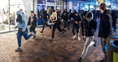 Protesters run during a pro-Palestinian demonstration during the Ajax - Maccabi Tel-Aviv match in Amsterdam