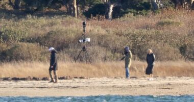 Jill Biden (right) and Ashley Biden (center) walk on their private beach as a Secret Service agent walks ahead of them