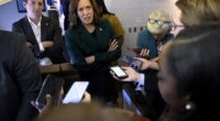 US Vice President and Democratic presidential candidate Kamala Harris speaks with members of the press aboard Air Force Two