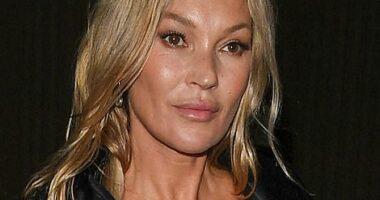 The mother of one wore a black satin trench slung over her shoulders and styled her blonde locks in soft waves, while showing off a smooth complexion which was enhanced with a bronze pallet of make-up