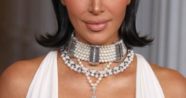 The reality star, 44, wowed in a plunging skintight white gown that highlighted her ample cleavage, accessorizing with a large cross necklace