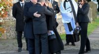 Simon Cowell is comforted by Liam Payne's father Geoff Payne (left) after the funeral today