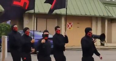 A group of Neo-Nazis carrying flags bearing swastikas were seen marching through the streets of Columbus, Ohio on Saturday afternoon - hurling racist and anti-Semitic chants at citizens