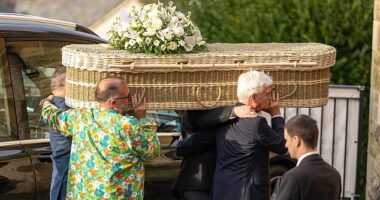 Phillip Schofield carries his mother's coffin which was topped by a beautiful floral bouquet