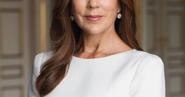 Queen Mary is seen posing in an elegant boat-neck cream dress and diamond earrings - with a delicate 'F' necklace around her neck