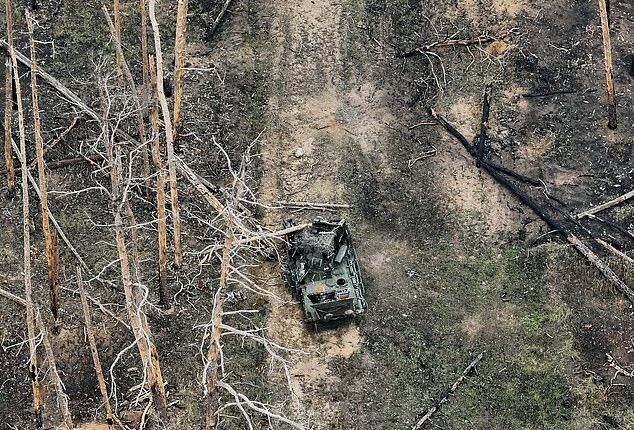 A view from a drone showing a destroyed Russian armoured vehicle in part of a forest where the hottest phase of the war is taking place on November 9, 2024. The forest is located about 8 kilometers southwest of Kreminna in the Luhansk Oblast, Ukraine