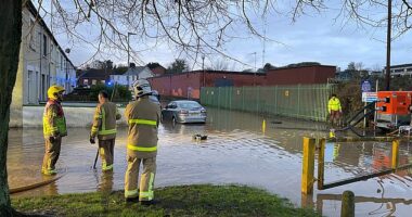 Firefighters work to pump water away from flooded residential streets near Moat Park in Dundonald on the outskirts of Belfast after Storm Bert battered the UK on Saturday