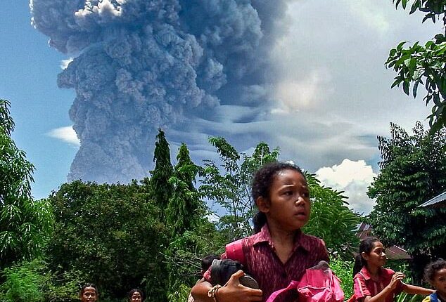 School children were seen running from Mount Lewotobi Laki-Laki in Indonesia when it first erupted (pictured)