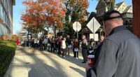 People wait in line outside the Bucks County government building to apply for an on-demand mail ballot on the last day to request one in Doylestown, Pa., Tuesday, Oct. 29, 2024
