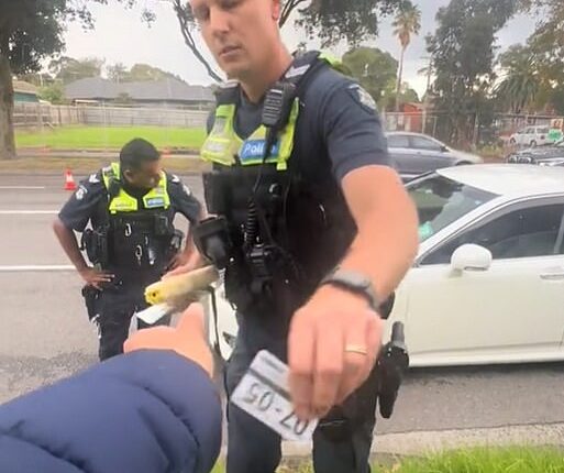 A Melbourne motorist has accused police of 'power tripping' after an escalated roadside argument stemmed from a driver trying to undercut traffic in an empty lane