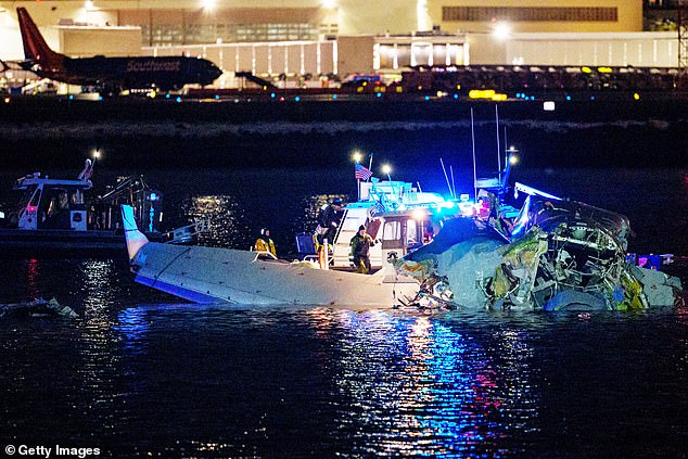 The pilot of the Black Hawk helicopter that collided with the American Airlines passenger airplane did not comply with directions to change course seconds before the fatal incident. (Pictured: Emergency crews rush to the scene after the crash)