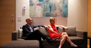 Canada's Prime Minister Mark Carney (pictured left) and his wife Diana Fox Carney (pictured right) watch the coverage of the election results at a hotel in downtown Ottawa