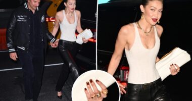 Gigi Hadid wears gold band on wedding ring finger at her birthday bash while with Bradley Cooper