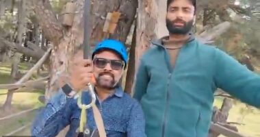 Rishi Bhatt (pictured left) can be seen soaring over the scene of a mass shooting which killed 26 people in Pahalgam, northern India on April 22 in the minute-long footage