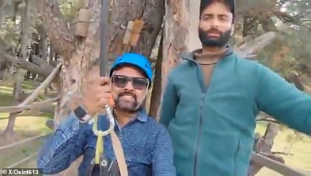 Rishi Bhatt (pictured left) can be seen soaring over the scene of a mass shooting which killed 26 people in Pahalgam, northern India on April 22 in the minute-long footage