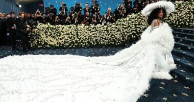 Ross hit fashion's biggest night in a low-cut, floor-length, crystal-covered gown topped by a larger-than-life white cape with feather trim