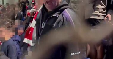 An Arsenal fan was caught on camera hurling racist and homophobic abuse at PSG supporters