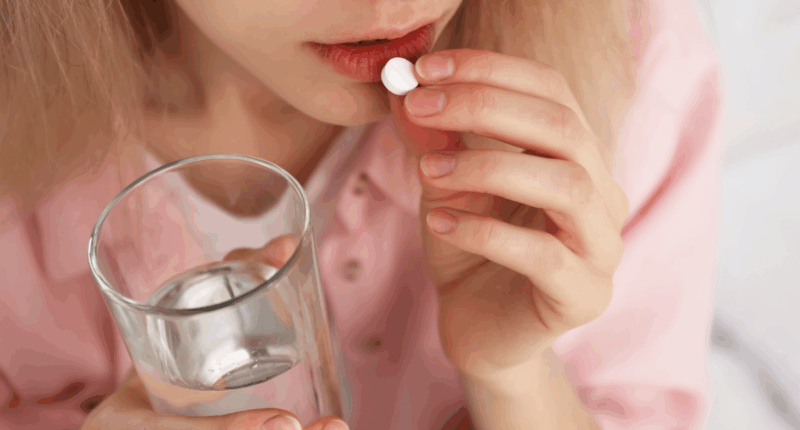 woman taking pill