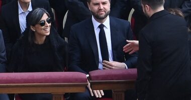 Volodymyr Zelensky (right) shook hands with JD Vance (centre) after spotting him sat in the front row for the new new Pope Leo XIV's inaugural mass