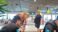 Pictured: The moment Wests Tigers star Jarome Luai (left) turns down a fan (second from left) who asked him for a selfie at Brisbane Airport last weekend while he was on a FaceTime call
