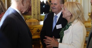 King Charles speaks with Alistair and Heather James, the parents of the late broadcaster Deborah James, during a reception in Buckingham Palace on Wednesday