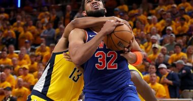 Karl-Anthony Towns is fouled by Tony Bradley of the Indiana Pacers during the fourth