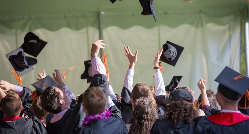 Graduating class tossing caps