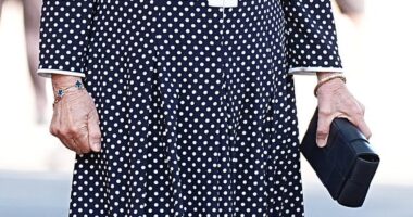 The Queen looked regal as she stepped out in an elegant polka dot monochrome Fiona Clare couture maxi dress, along with comfortable black heels and a matching clutch bag