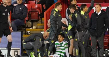 Reo Hatate is tended to by the medics as a furious Brendan Rodgers looks on in disbelief