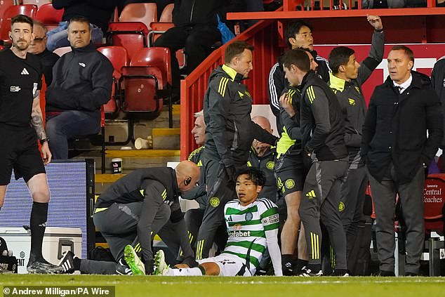 Reo Hatate is tended to by the medics as a furious Brendan Rodgers looks on in disbelief