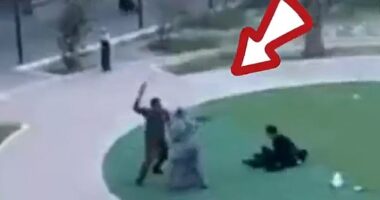 A man wielding a belt or leather strap rushes appears to attack women who were protesting