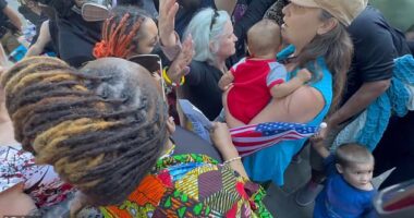 One woman, seen here in the blue top, was spotted attempting to get through the counter protest who pointed and shouted in her face as she carried her baby