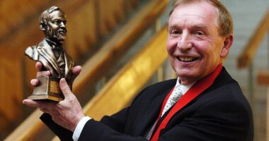 Sir Tom with his Andrew Carnegie Medal of Philanthropy award at the Scottish Parliament