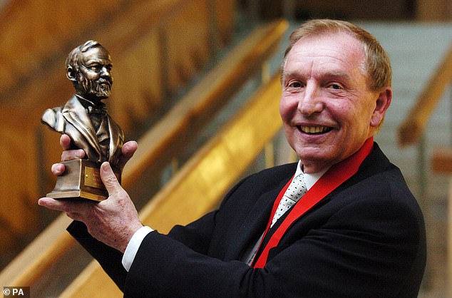 Sir Tom with his Andrew Carnegie Medal of Philanthropy award at the Scottish Parliament