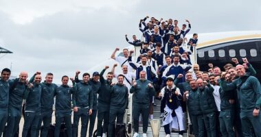 Tottenham smiled for a team photo after landing in England with the Europa League trophy