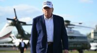 US President Donald Trump walks to speak to journalists before boarding Air Force One from Morristown Municipal Airport in Morristown, New Jersey
