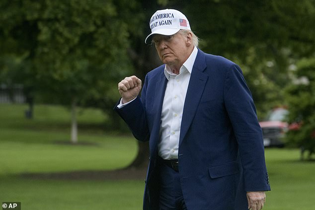 President Donald Trump acknowledges reporters as he disembarks Marine One upon arrival on the South Lawn of the White House