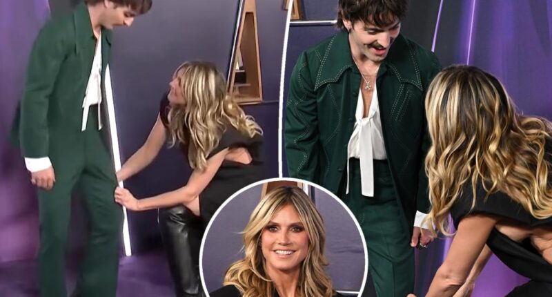 Watch Heidi Klum attempt to pants Benson Boone in awkward AMAs 2025 red carpet video